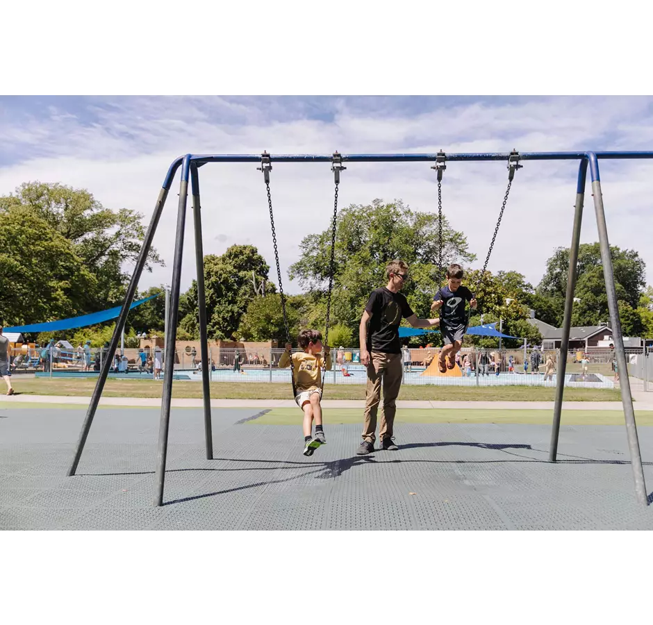 Children On Swings At The Botanic Garden Playground
