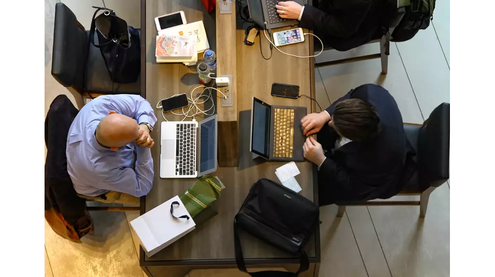 Business Businessmen Working on Laptops from above Credit Scott Winterroth