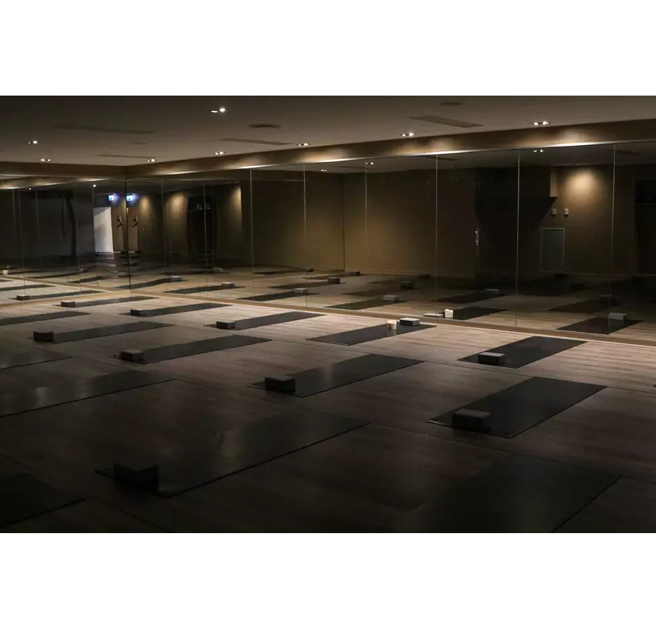 Soul yoga studio set up for a class, lights are dim, mats laid out on the floor
