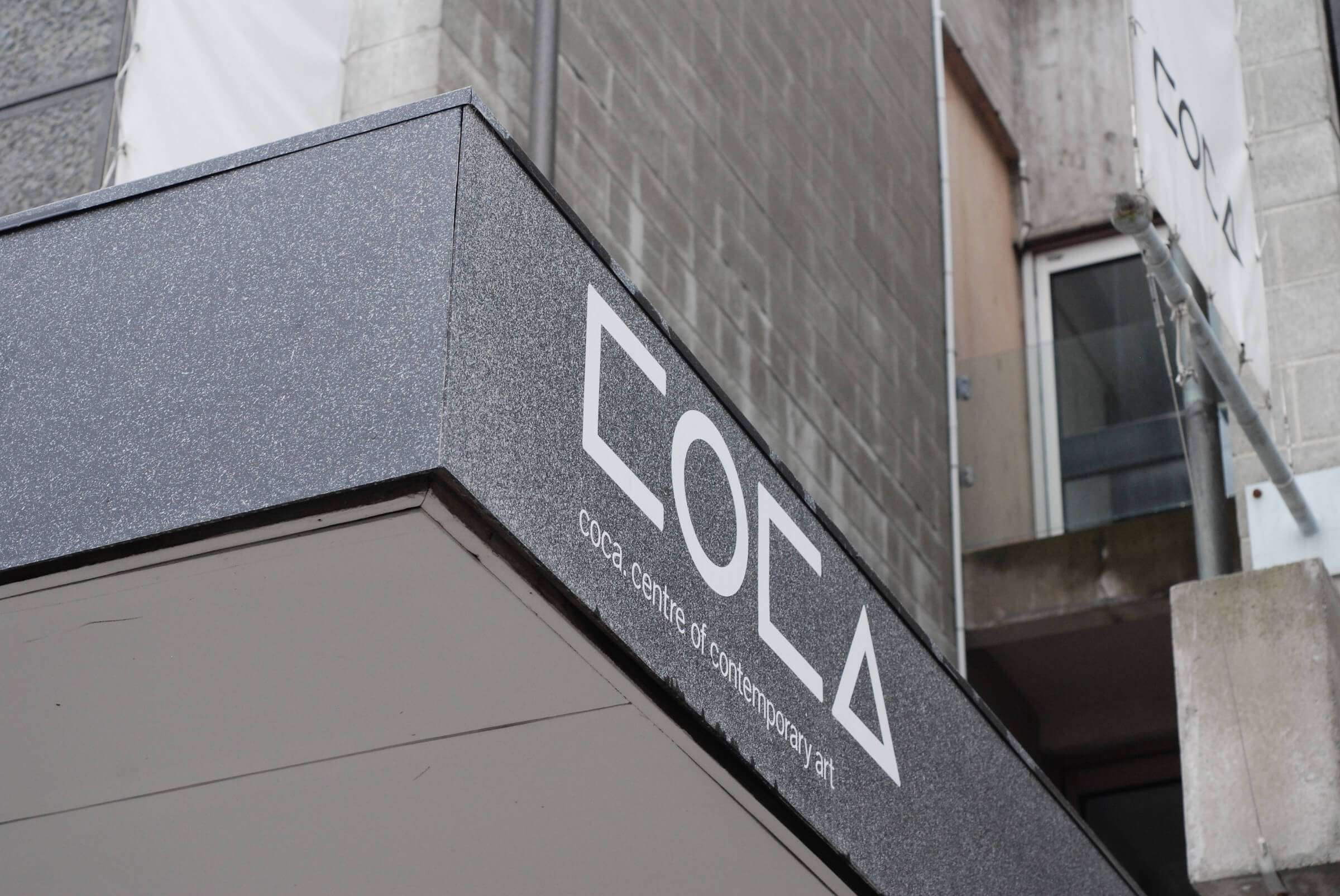 Coca Art Gallery Logo text on marble background