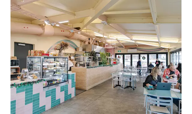 Interior of Saturdays cafe in New Brighton, people enjoying the beach view and food.