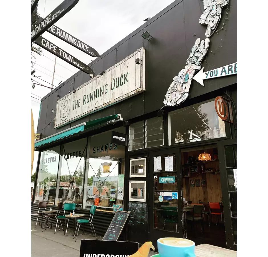 The Running Duck exterior of cafe with chairs and tables outside.
