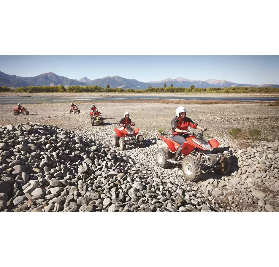 Quad Bike travel across the stony riverbank